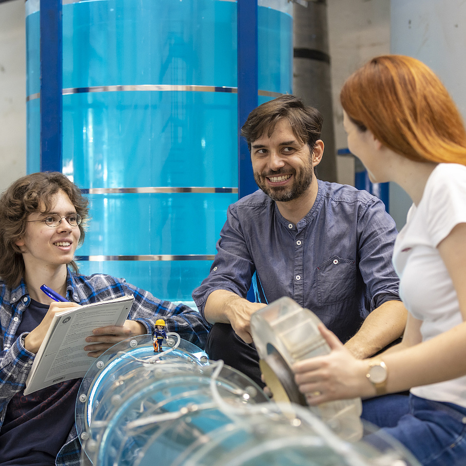 People in a water laboratory talk to each other