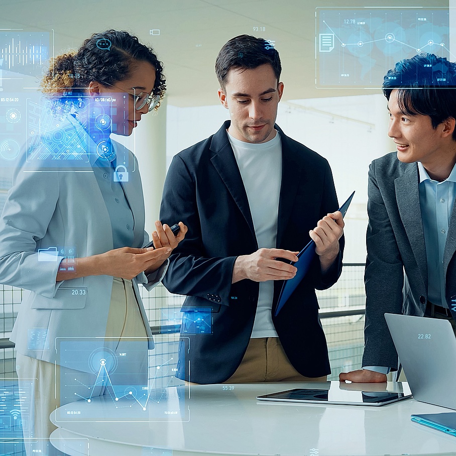 A young woman and two young men working in a team, business attire, partial overlay with transparent digital screens 