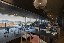 Interior of a restaurant with a view over a city.